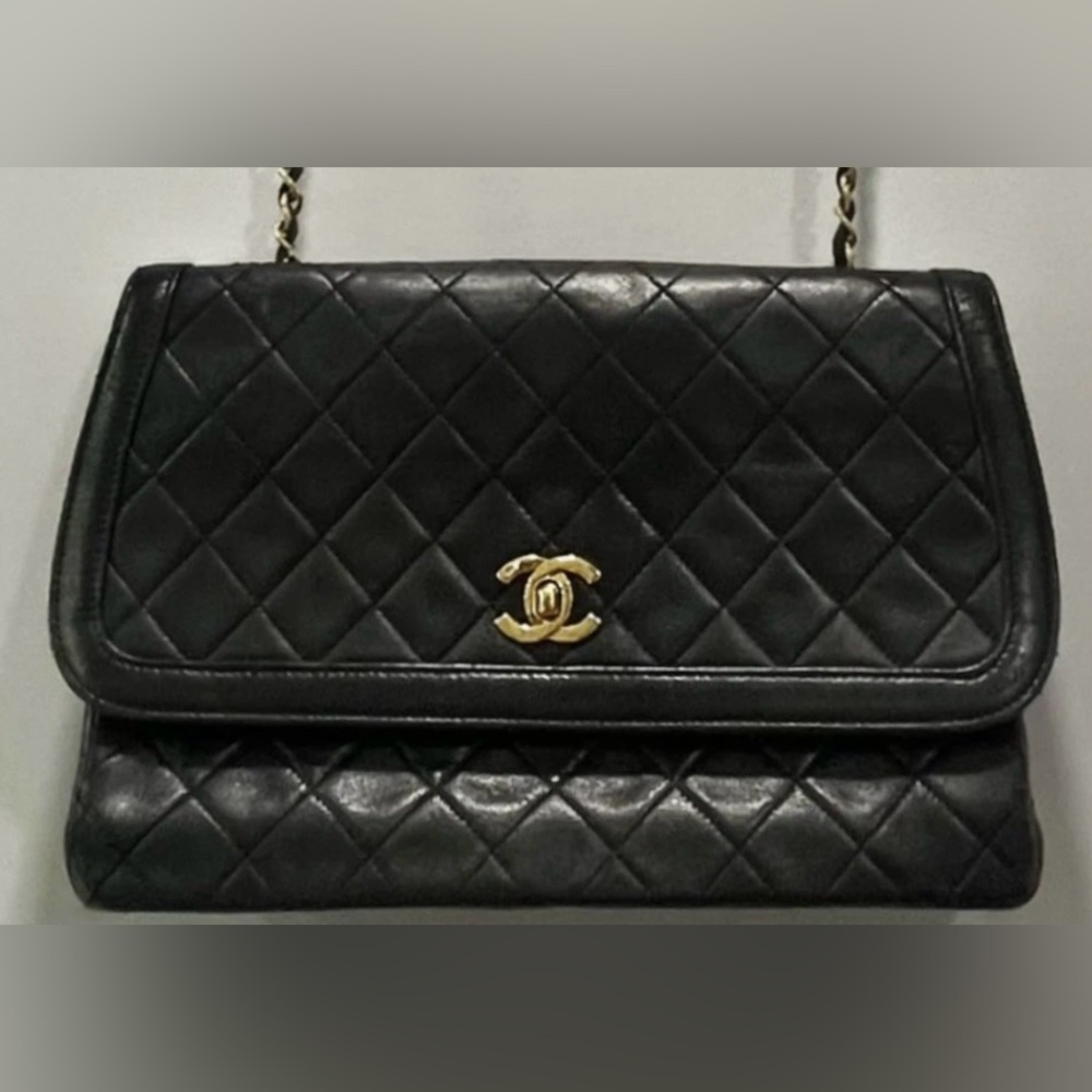 CHANEL Black Quilted Flap Bag with Gold Logo